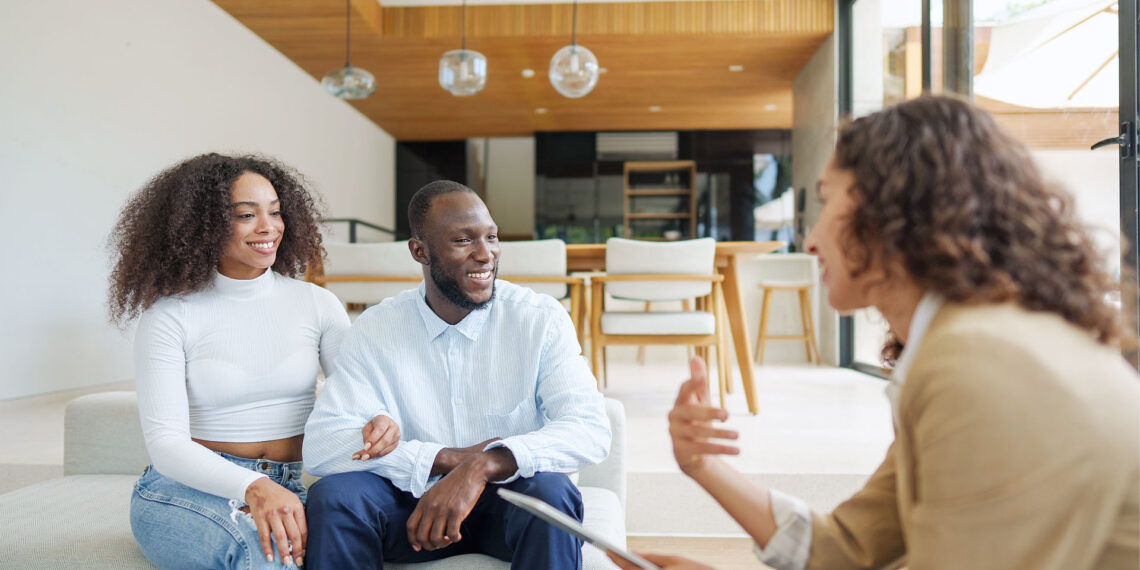 A professional real estate agent conducting a strategic home buying consultation with a client in a modern coffee shop.